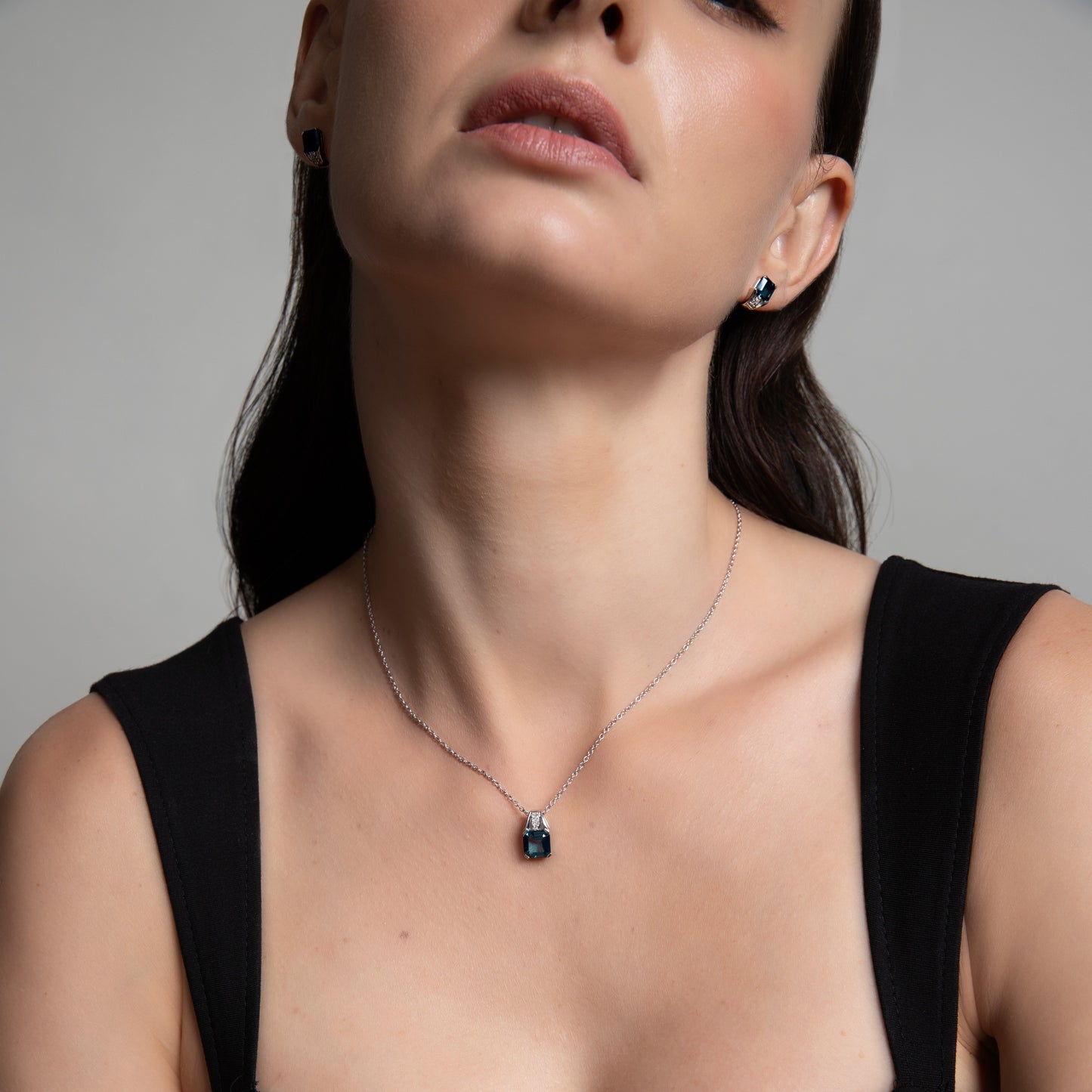 Le Petite Folie: Iolite Emerald Cut 4-Prong Pendant Necklace with White Topaz Accents in Rhodium Plated 925 Silver