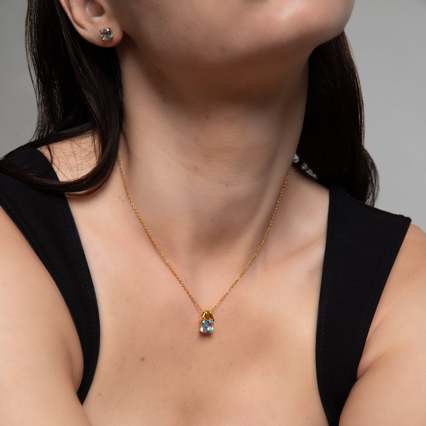 Le Petite Folie: Light Blue Topaz Princess Cut Tension Set Pendant Necklace in Gold Plated 925 Sterling Silver