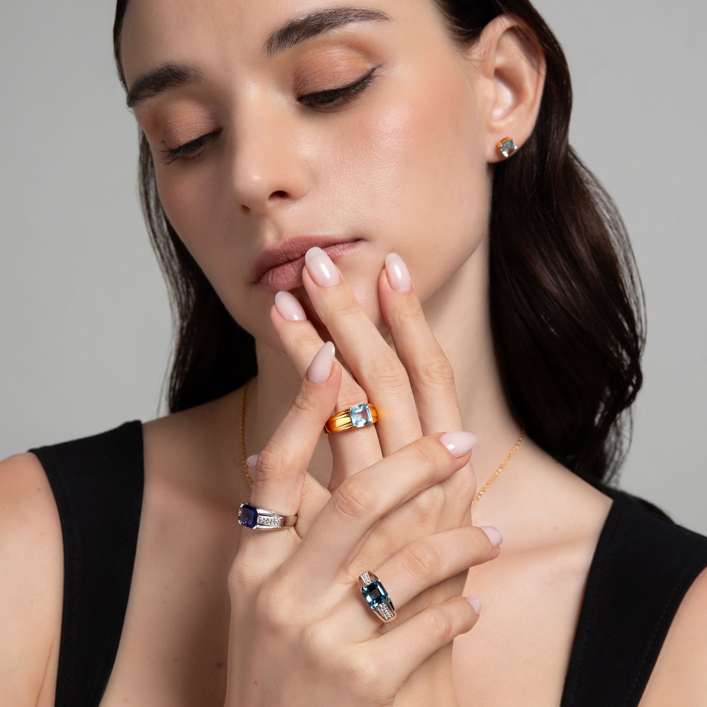 Le Petite Folie: London Blue Topaz Emerald Cut 4-Prong Band Ring with White Topaz Accents in Rhodium Plated 925 Silver