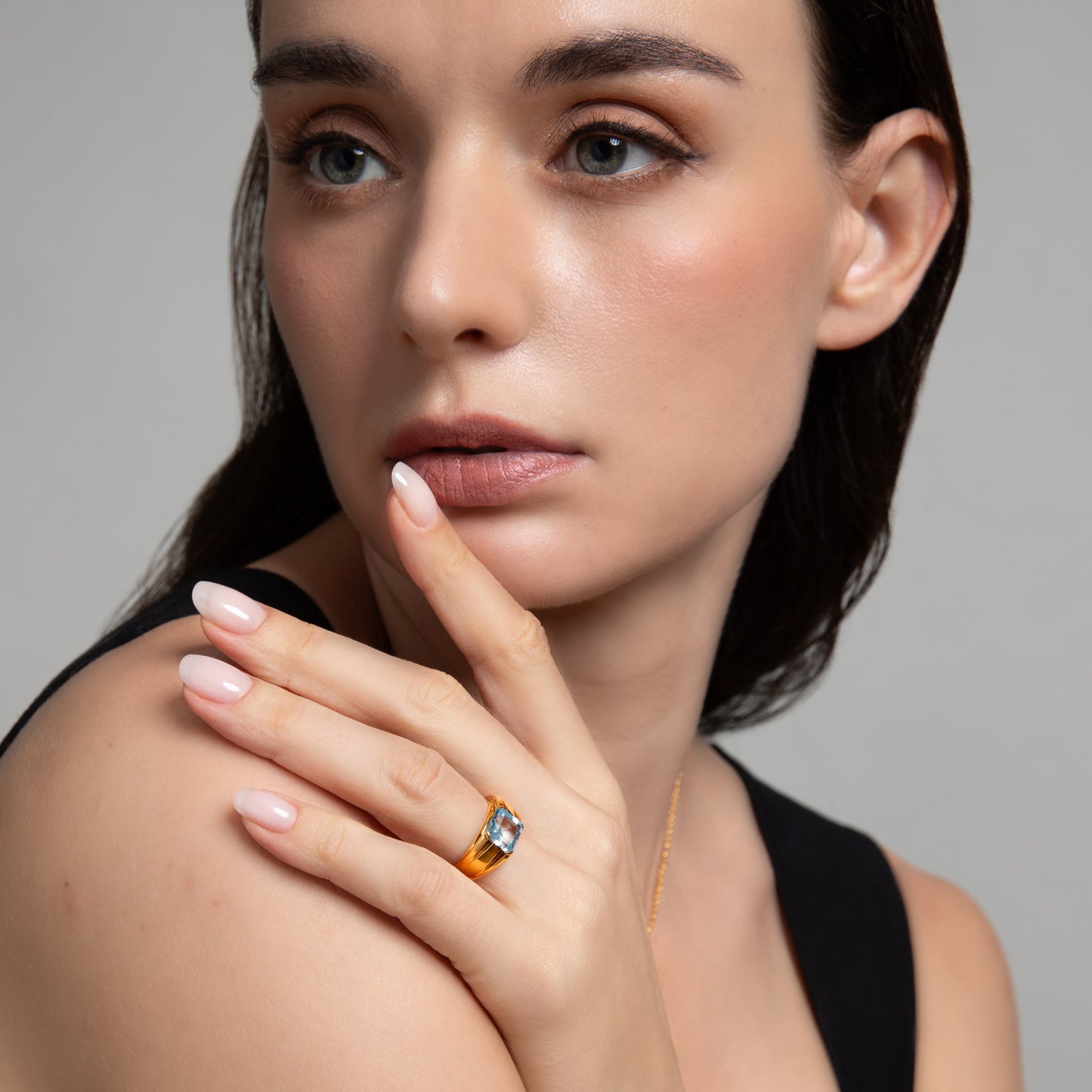 Le Petite Folie: Light Blue Topaz Princess Cut Tension Set Band Ring in Gold Plated 925 Sterling Silver