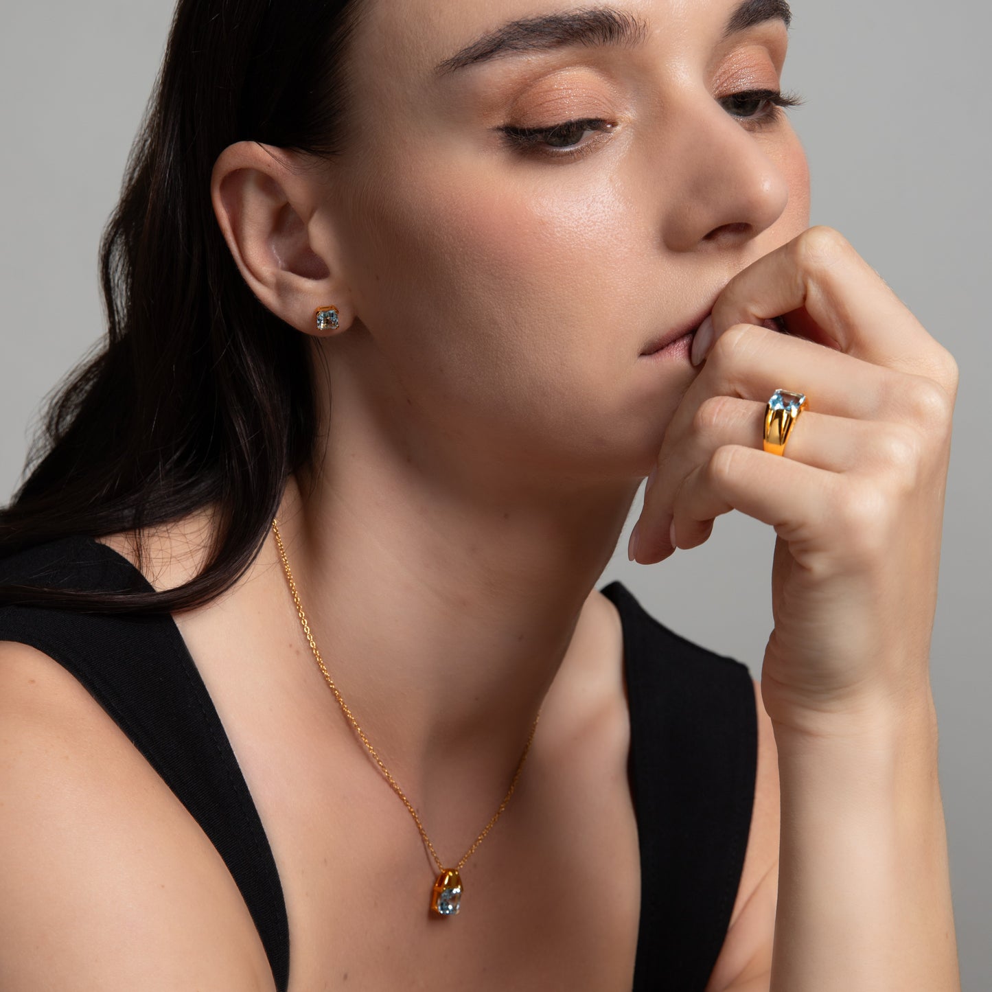 Le Petite Folie: Light Blue Topaz Princess Cut 4-Prong Stud Earrings in Gold Plated 925 Sterling Silver