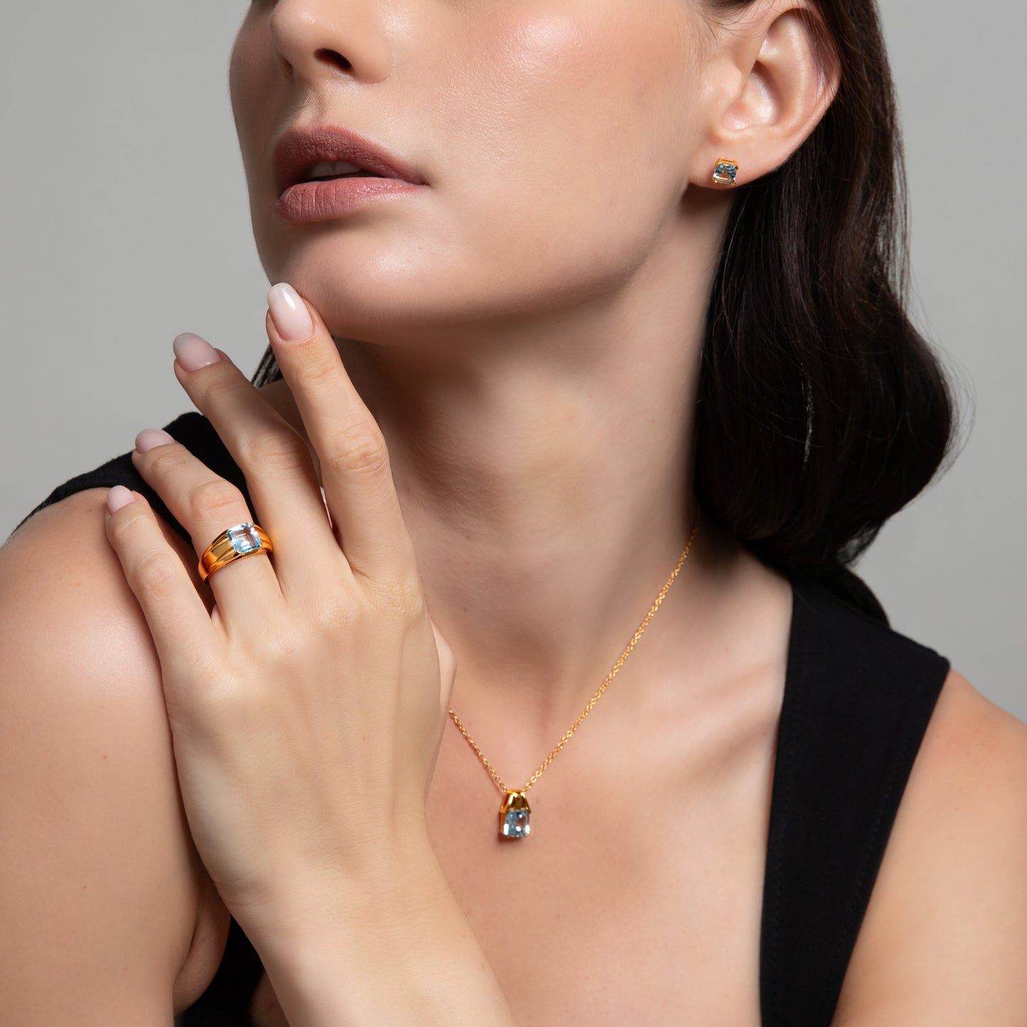 Le Petite Folie: Light Blue Topaz Princess Cut 4-Prong Stud Earrings in Gold Plated 925 Sterling Silver